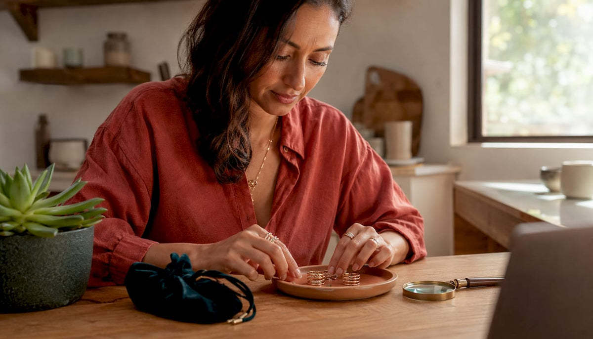 Jewelry stylist arranging stacked rings at studio counter