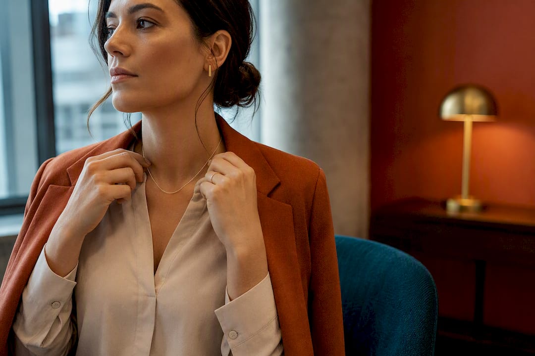 Woman styling subtle jewelry for work