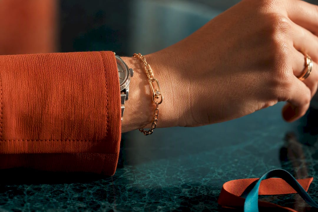 Cropped wrist testing bracelet beside watch