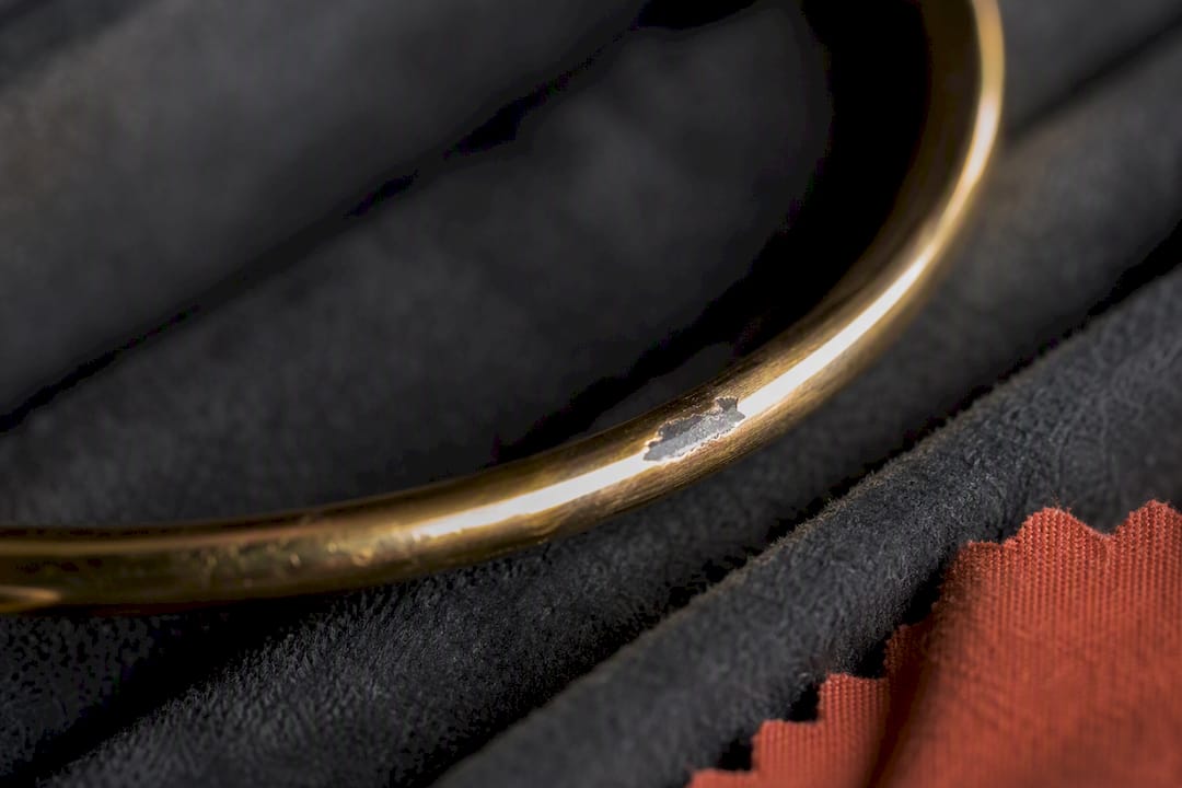 Worn gold plating revealing base metal