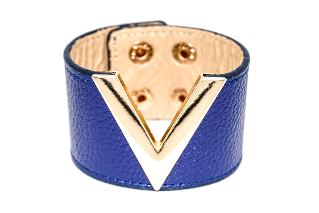 Blue leather bracelet with gold triangle design on a white background